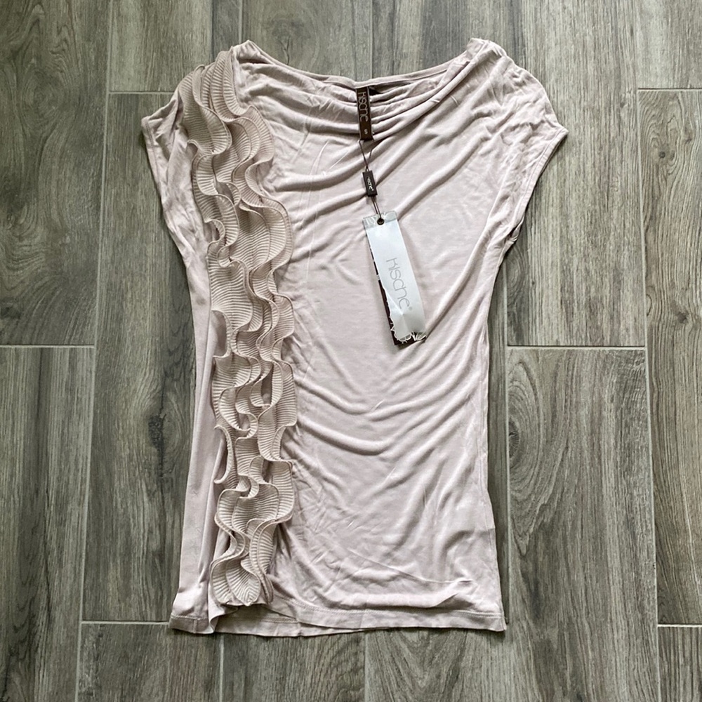 Beautiful cap sleeved 100% rayon blouse with ruffled details on one side.